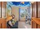 The bedroom has a whimsical mural and cloud painted ceiling, complemented by natural light from the window at 2225 Maryday Ct, Orlando, FL 32812