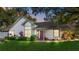 Charming home with lush landscaping, a red door, and large windows creating a welcoming curb appeal at 2225 Maryday Ct, Orlando, FL 32812