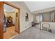 A hallway features neutral walls, an open doorway to a living room, and a passthrough to the kitchen at 2225 Maryday Ct, Orlando, FL 32812