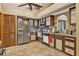 A kitchen features stainless steel appliances, wood cabinets, and a tiled floor at 2225 Maryday Ct, Orlando, FL 32812