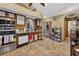 Traditional kitchen featuring tiled floor, stainless steel appliances, and brown cabinets at 2225 Maryday Ct, Orlando, FL 32812