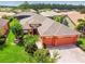 Aerial view of the home featuring a well-manicured lawn and three car garage at 271 Indian Wells Ave, Poinciana, FL 34759