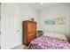 This bedroom features a closet, a bed, and modern artwork at 271 Indian Wells Ave, Poinciana, FL 34759