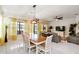 The open-concept living area includes a dining area with a stylish table and modern light fixture at 271 Indian Wells Ave, Poinciana, FL 34759