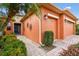 Close up of the charming home with brick walkway, colorful flowers, and a blue front door at 271 Indian Wells Ave, Poinciana, FL 34759