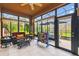 Bright sunroom with comfortable seating, tile floors, and views of the landscaped backyard, great for relaxing or entertaining at 271 Indian Wells Ave, Poinciana, FL 34759