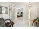 This spacious foyer has tile floors, a modern light fixture, and a view of the living room at 271 Indian Wells Ave, Poinciana, FL 34759