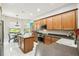 Bright kitchen featuring wood cabinetry, modern appliances, and a view of the backyard at 271 Indian Wells Ave, Poinciana, FL 34759