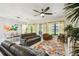 Spacious living room with tile flooring, ceiling fan, large windows, and comfortable furnishings at 271 Indian Wells Ave, Poinciana, FL 34759