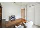 A view of the office featuring a large desk with a rolling chair and a closet at 271 Indian Wells Ave, Poinciana, FL 34759