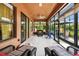 This bright sunroom features glass windows, tile floors, and wicker furniture at 271 Indian Wells Ave, Poinciana, FL 34759