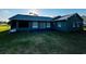 View of the backyard with a patio, showcasing the home's exterior and landscaping at 2805 Rodeo Dr, Kissimmee, FL 34746