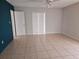 A spacious bedroom with tile flooring, featuring a ceiling fan and natural light at 2805 Rodeo Dr, Kissimmee, FL 34746