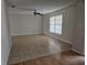 Open living room with tile flooring, a ceiling fan, and a large window for natural light at 2805 Rodeo Dr, Kissimmee, FL 34746