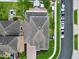 An aerial view of the home showing the roof, driveway, and surrounding landscape at 2939 Sera Bella Way, Kissimmee, FL 34744