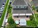 An aerial view of the backyard featuring a patio, fire pit, hot tub, and gazebo with well-maintained landscaping at 2939 Sera Bella Way, Kissimmee, FL 34744