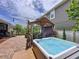 Relaxing backyard with a hot tub, gazebo, and paved patio at 2939 Sera Bella Way, Kissimmee, FL 34744