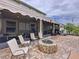Lovely backyard patio features a stone fire pit and ample seating at 2939 Sera Bella Way, Kissimmee, FL 34744