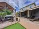 Relaxing backyard with a shaded patio, outdoor seating, hot tub, and a cozy fire pit at 2939 Sera Bella Way, Kissimmee, FL 34744