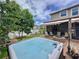 Picturesque backyard featuring a hot tub, fire pit, and hammock at 2939 Sera Bella Way, Kissimmee, FL 34744