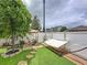 Cozy backyard with green turf, decorative stones, and a charming seating area with a hammock at 2939 Sera Bella Way, Kissimmee, FL 34744