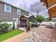 Inviting backyard with a cozy gazebo and a brick-paved patio with mature plants and synthetic lawn area at 2939 Sera Bella Way, Kissimmee, FL 34744
