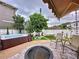 Secluded backyard with a hot tub, fire pit, and lush landscaping at 2939 Sera Bella Way, Kissimmee, FL 34744