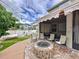 Comfortable backyard features a stone fire pit, patio area, and hammock at 2939 Sera Bella Way, Kissimmee, FL 34744