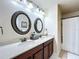 Bathroom featuring double sinks, quartz countertops, and modern fixtures for a spa-like feel at 2939 Sera Bella Way, Kissimmee, FL 34744