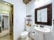 This bright bathroom has a shower with a curtain and a vanity at 2939 Sera Bella Way, Kissimmee, FL 34744