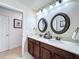 Bathroom featuring double sinks, quartz countertops, and modern fixtures for a spa-like feel at 2939 Sera Bella Way, Kissimmee, FL 34744
