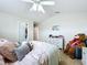 Bright bedroom features a ceiling fan, closet, and dresser at 2939 Sera Bella Way, Kissimmee, FL 34744