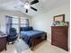 Bedroom showcases desk, ceiling fan, and an earthy color scheme at 2939 Sera Bella Way, Kissimmee, FL 34744