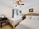 Bedroom with two full beds, neutral decor, and natural light for a bright atmosphere at 2939 Sera Bella Way, Kissimmee, FL 34744