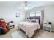 Bedroom with pink bedding, plush decor, and soft, filtered light at 2939 Sera Bella Way, Kissimmee, FL 34744