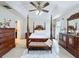 Bedroom with dark wood furniture and soft, natural lighting at 2939 Sera Bella Way, Kissimmee, FL 34744