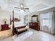 Bedroom with dark wood furniture and a decorative ceiling fan at 2939 Sera Bella Way, Kissimmee, FL 34744