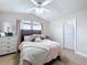 Bedroom featuring tile floors, bright lighting, and simple color scheme at 2939 Sera Bella Way, Kissimmee, FL 34744