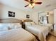 Comfortable bedroom with two full beds, mirrored closet, and ceiling fan at 2939 Sera Bella Way, Kissimmee, FL 34744