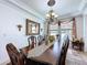 Dining room with an elegant table set, chandelier lighting, and decorative wall accents at 2939 Sera Bella Way, Kissimmee, FL 34744