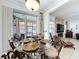 Elegant dining room with glass table set, chandelier, and sliding door to the patio at 2939 Sera Bella Way, Kissimmee, FL 34744