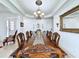 Spacious dining room featuring a long wooden table, ornate chairs, and elegant lighting at 2939 Sera Bella Way, Kissimmee, FL 34744