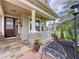 Inviting front porch with stone accents, decorative seating, and a welcoming entrance at 2939 Sera Bella Way, Kissimmee, FL 34744