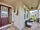 Inviting front porch with stone accents, decorative seating, and a welcoming entrance at 2939 Sera Bella Way, Kissimmee, FL 34744