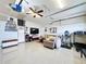 Finished garage with tile floors, a ceiling fan, seating, and a tv at 2939 Sera Bella Way, Kissimmee, FL 34744