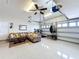 Spacious garage converted into a living area with a comfortable sofa and plenty of light at 2939 Sera Bella Way, Kissimmee, FL 34744
