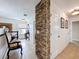 Upstairs hallway featuring a stone accent wall and decorative furniture in neutral tones at 2939 Sera Bella Way, Kissimmee, FL 34744