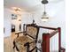 Hallway features a decorative chair and chandelier, providing warm and inviting lighting at 2939 Sera Bella Way, Kissimmee, FL 34744
