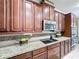 Well-lit kitchen featuring granite countertops, stainless steel appliances, and ample cabinet space at 2939 Sera Bella Way, Kissimmee, FL 34744