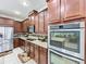 Spacious kitchen featuring granite countertops, stainless steel appliances, and ample cabinet space at 2939 Sera Bella Way, Kissimmee, FL 34744